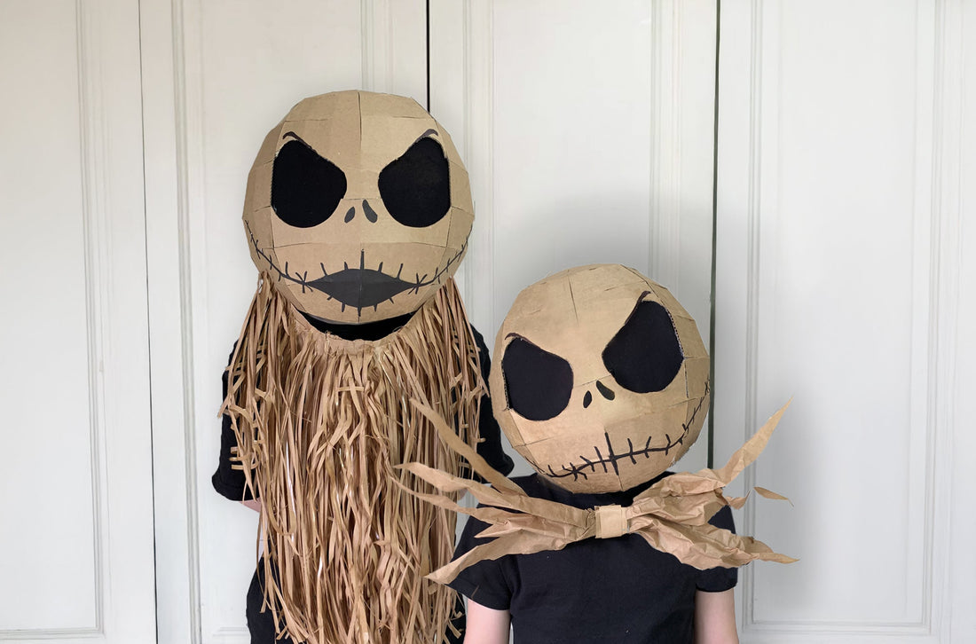 Two kids dressed up in cardboard nightmare skeleton masks inspired to look like Jack Skellington.