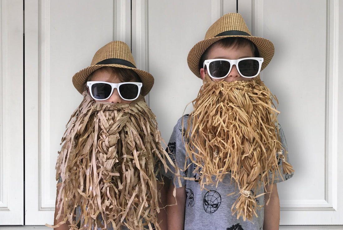 Two boys wearing hand made paper beards made from a Free paper template