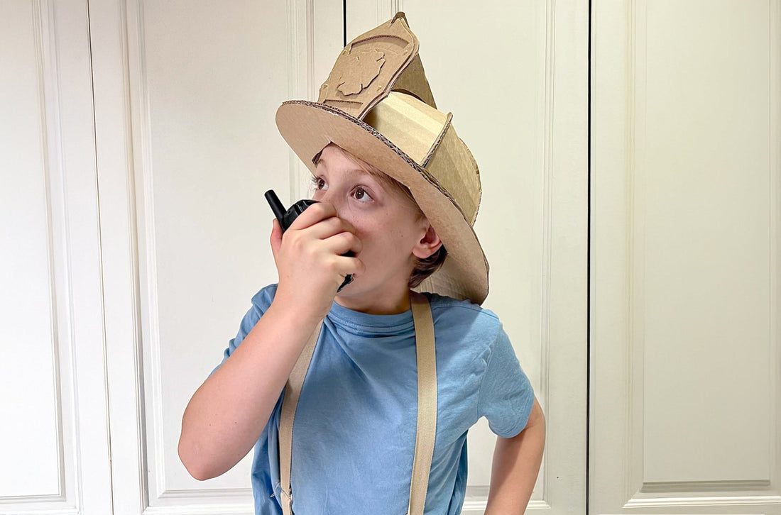 Child dressed up as a Fireman wearing a Cardboard fireman helmet