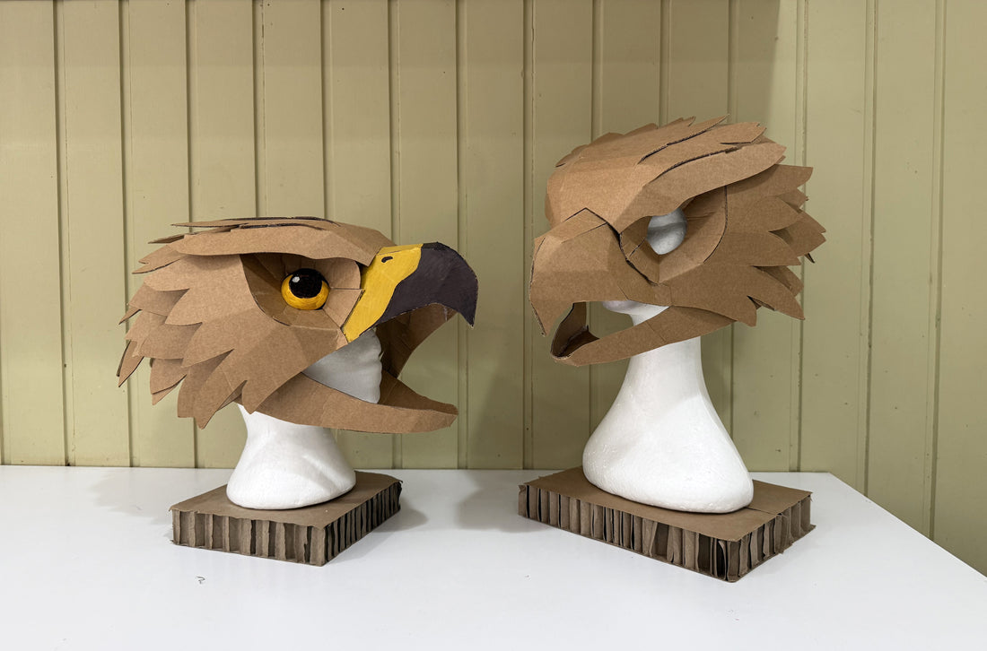 Two Falcon Hawk masks made out of cardboard from a template by Zygote Brown Designs.