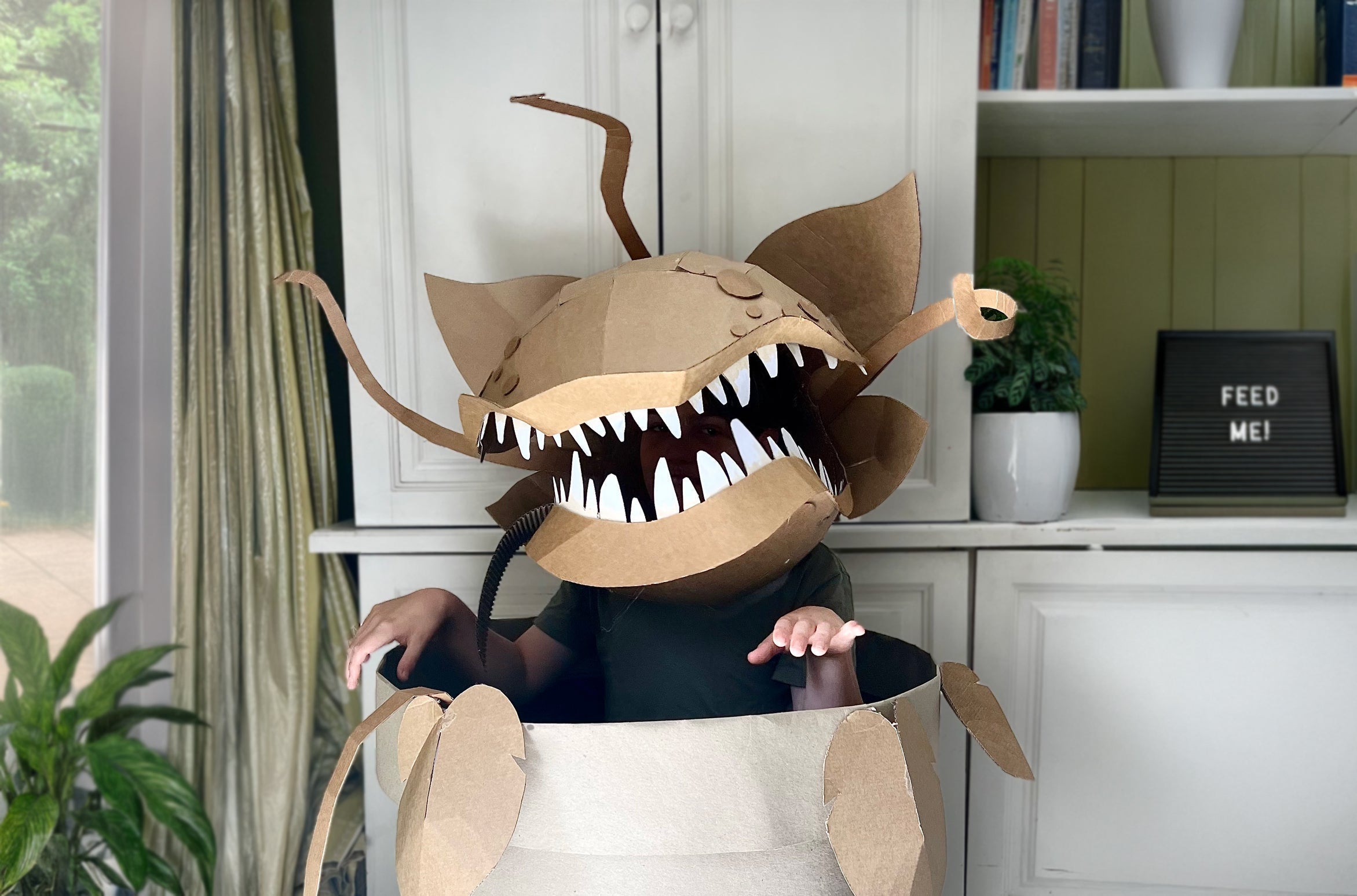 Man eating plant costume in pot inspired by Audrey 2