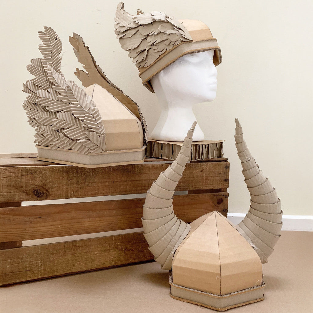 Cardboard viking helmets with wings and horns.