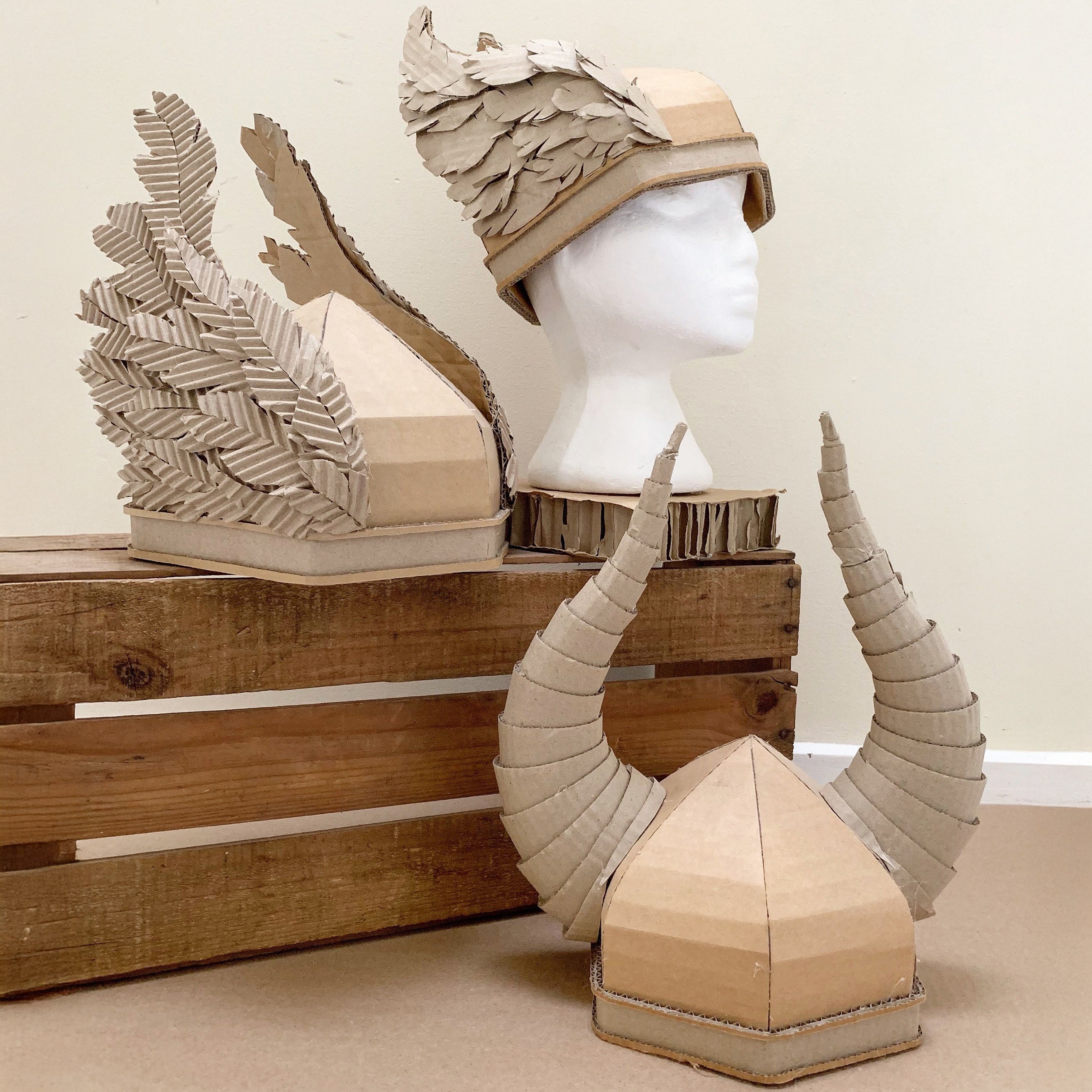 Cardboard viking helmets with wings and horns.