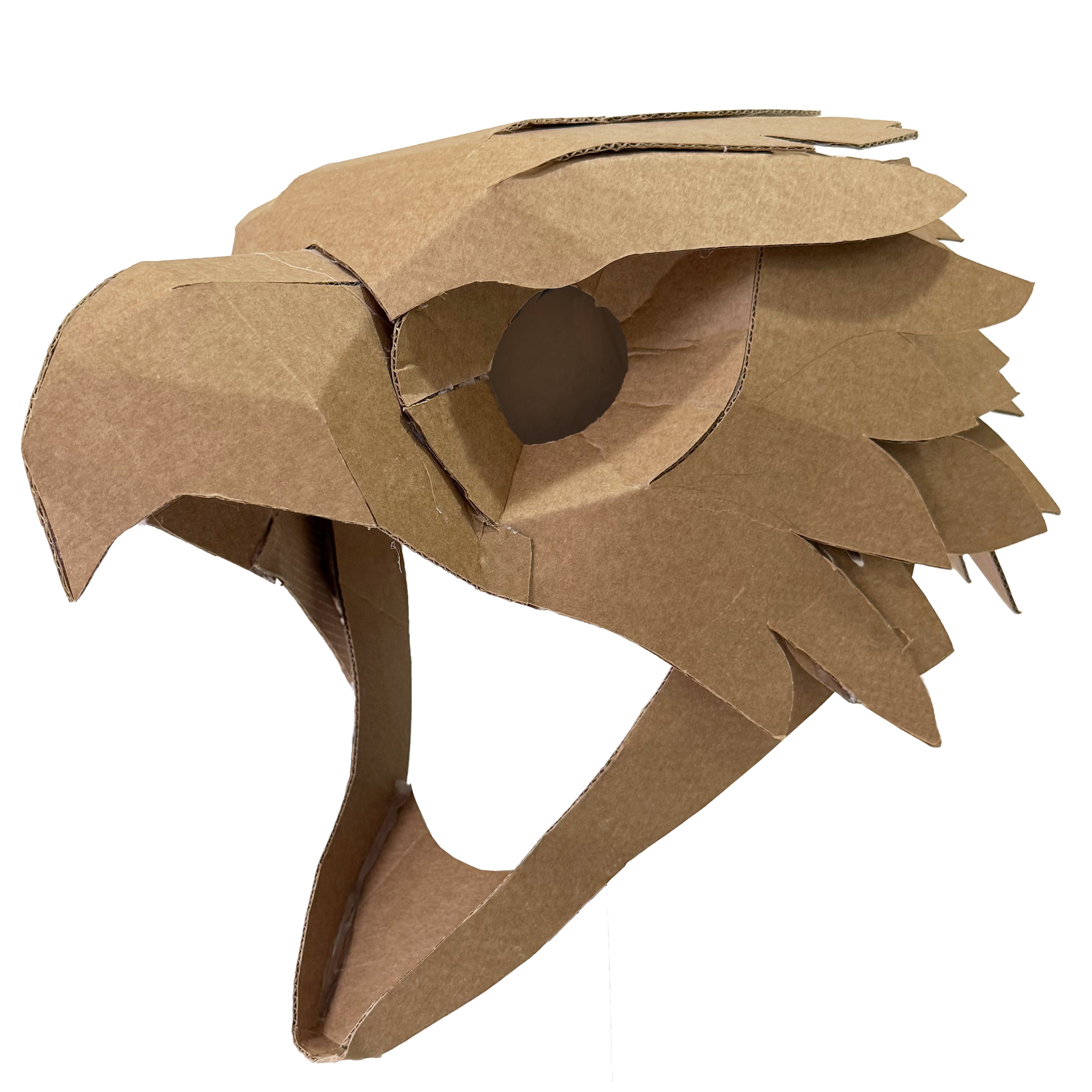 A handmade cardboard eagle , falcon, hawk head mask or costume, crafted from layered corrugated cardboard with a circular cutout for the eye, shown against a plain white background.