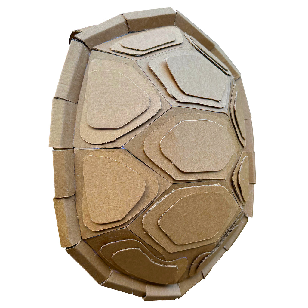 Cardboard turtle shell costume with hexagonal patterns on a white background